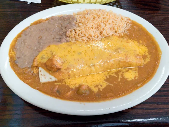Smothered burrito plate with refried beans and Mexican rice