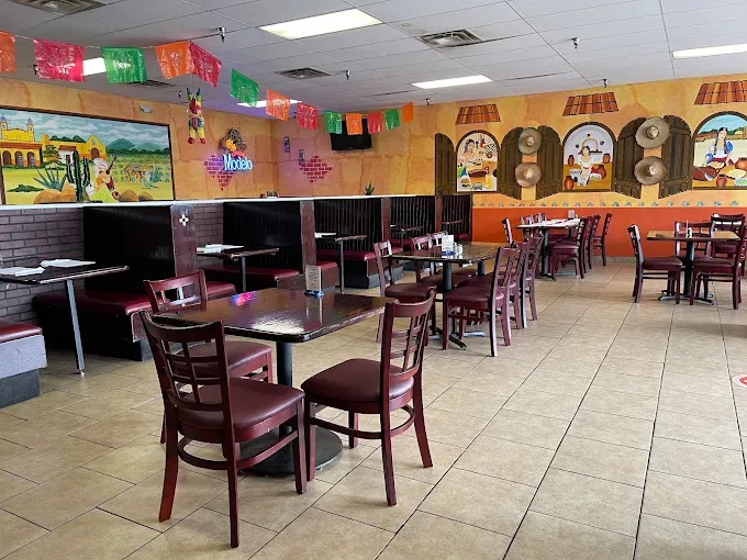The La Puente dining room, with wooden booths and tables set for lunch service